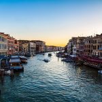 View of the Grand Canal in Venice with sun falling on horizon
