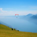 Monte Baldo mountain italy, paraglider floating over lake garda.