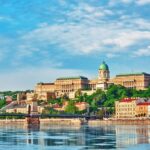 Budapest Royal Castle and Szechenyi Chain Bridge at day time from Danube river.